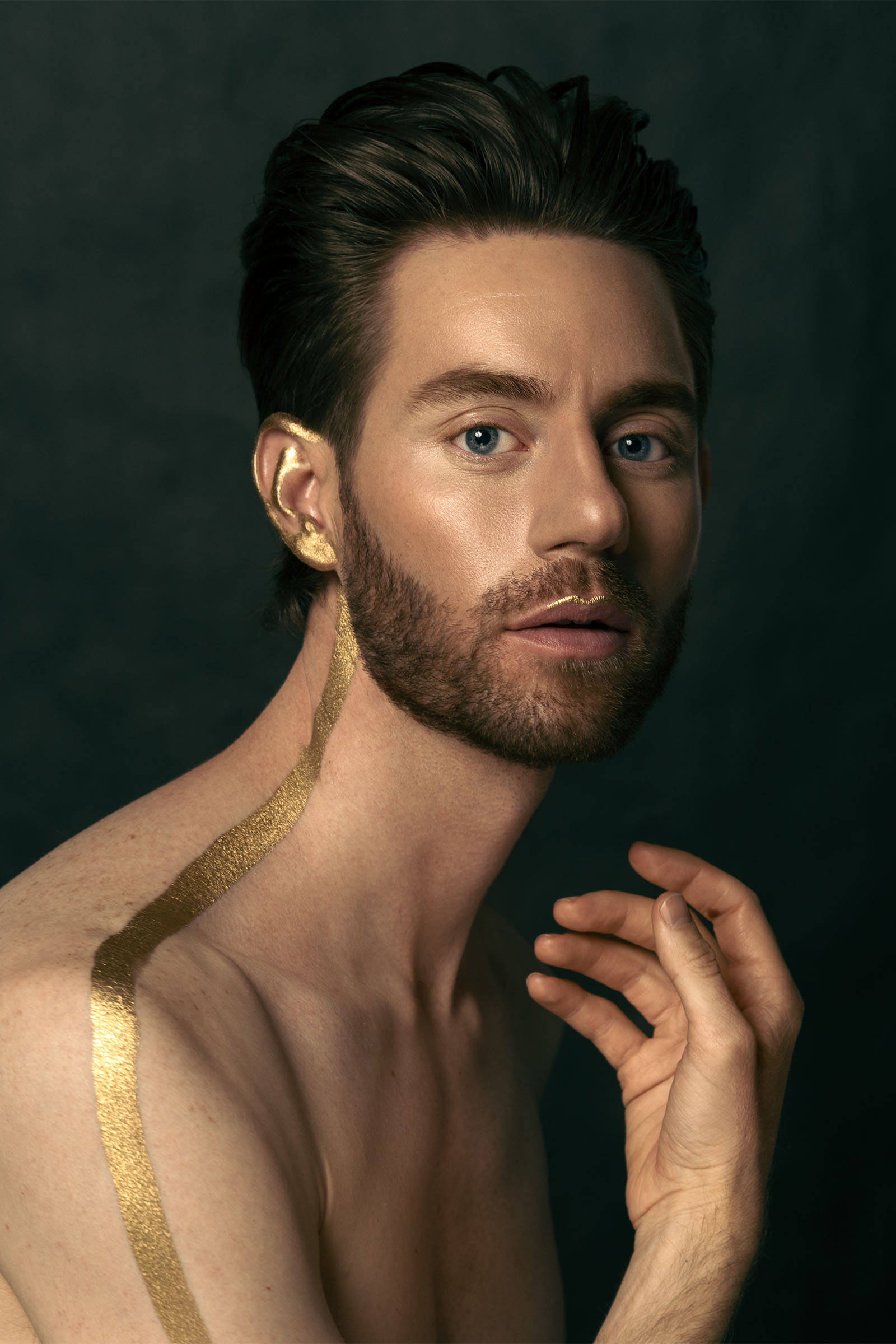 Male editorial beauty portrait featuring conceptual, modern makeup in gold by Utah photographer Christopher Loke